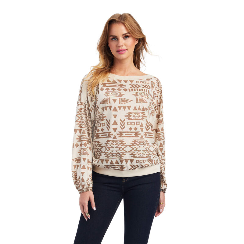 A Woman in a Cream Sweater With Brown Geometric Prints