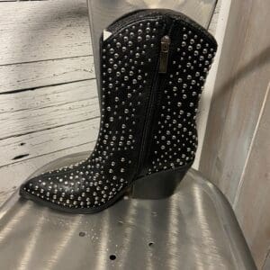 A pair of black boots with silver studs on top.
