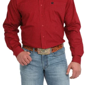 A man wearing jeans and red shirt with a belt around his waist.