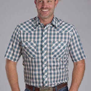 A man wearing a plaid shirt and jeans.