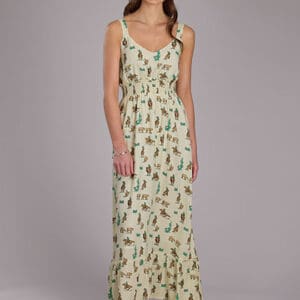 A woman in a long dress standing on the street.