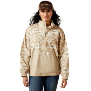 A woman wearing a tan jacket and hat.