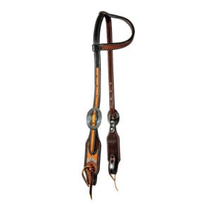 A pair of leather horse reins hanging on the wall.