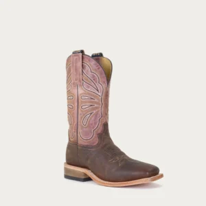 A brown cowboy boot with pink accents on top of it.