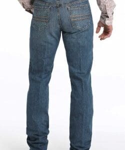 A man wearing jeans and a cowboy hat.